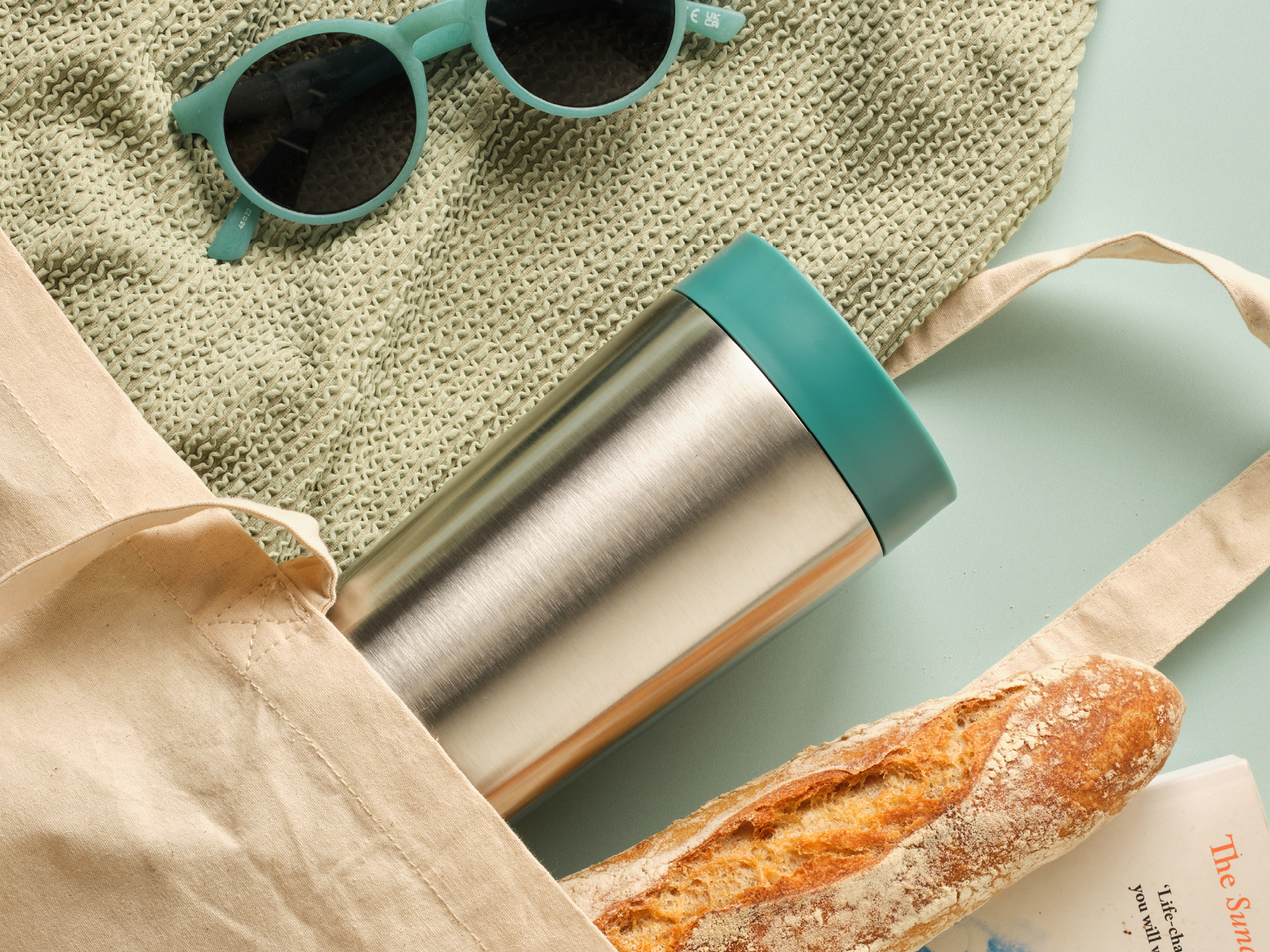 sustainable travel mug displayed in a shopping bag